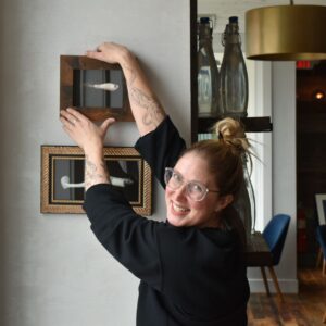 Elizabeth Hanging up Gallery Wall in The Shipwright's daughter