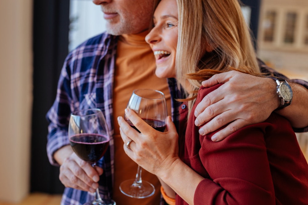 Couple drinking wine and enjoying an elevated Valentine's Day getaway at our Boutique Mystic Hotel